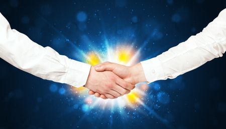 Two business men shaking hands with a successes agreement with explosion 
