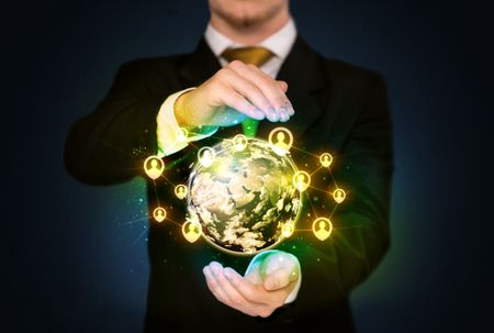 Businessman holding a shining globe with social media connection 