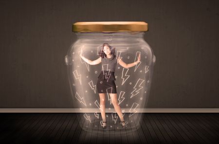 Businesswoman inside a glass jar with lightning drawings concept on background