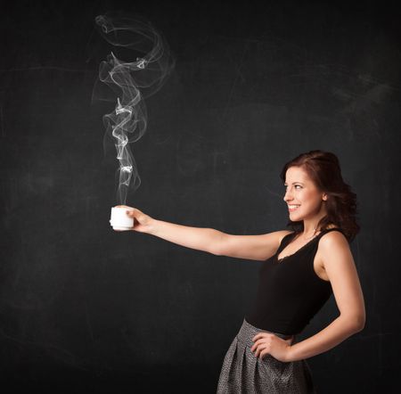 Businesswoman standing and holding a white steamy cup on a black background