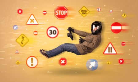 Young driver with road signs around him concept