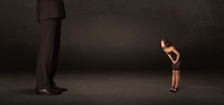 Huge man with small businesswoman standing at front concept on background