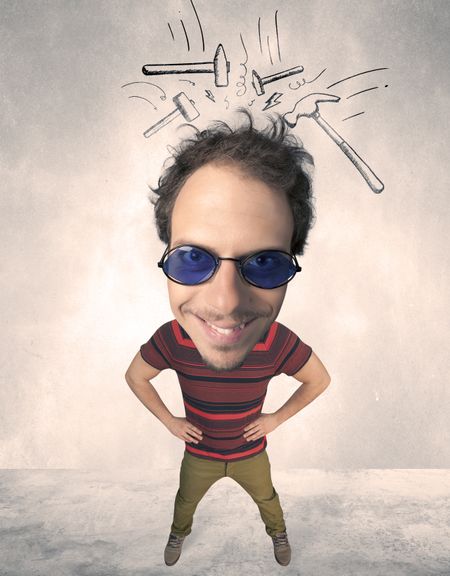 Funny person with big head and drawn punching hammers over it 