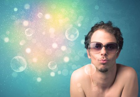 Young man with sunglasses and bokeh colourful lights concept