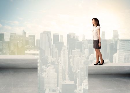 Businesswoman standing on the edge of rooftop with city background 