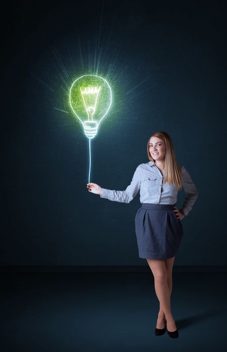 Businesswoman hold a shining idea bulb on a blue background