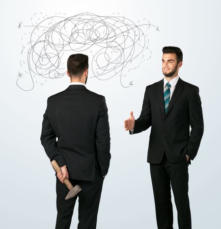 ruthless-businessman-hiding-weapon-weaving-plan-339780824 Ruthless businessman hiding a weapon and weaving plan around his head