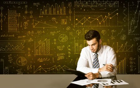 Businessman sitting at black table with hand drawn diagram background 