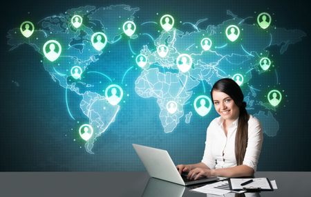 Businesswoman sitting at table with social media connection symbols on the world map
