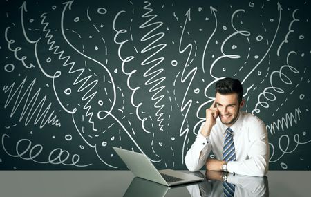 Businessman sitting at table with drawn curly lines and arrows on the background 