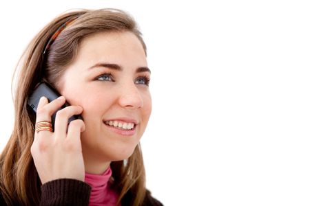 casual woman smiling and talking on a mobile phone - isolated over a white background