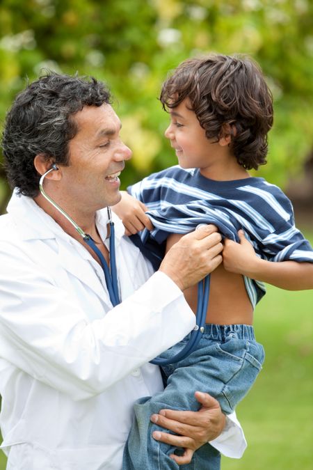 Male pediatrician with his son smiling outdoors