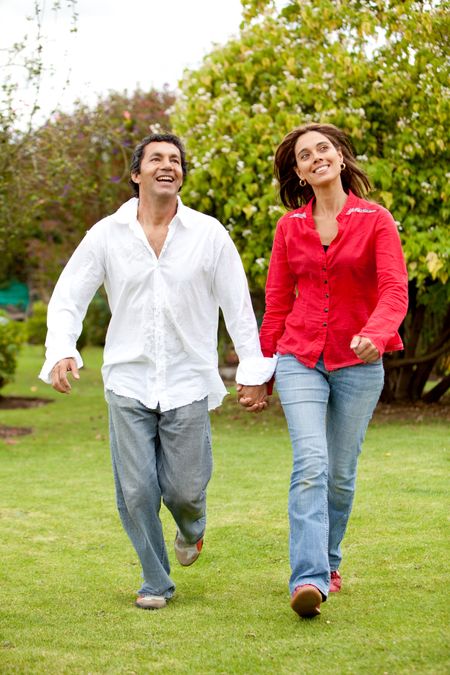 happy young couple running outdoors