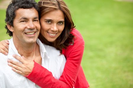 Beautiful couple smiling and looking happy outdoors