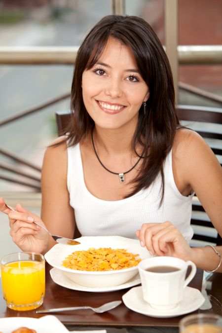 casual woman at home having breakfast and smiling