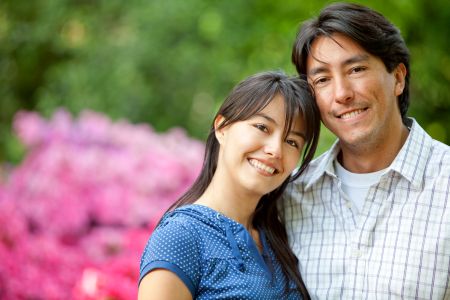 couple portrait looking happy and smiling outdoors