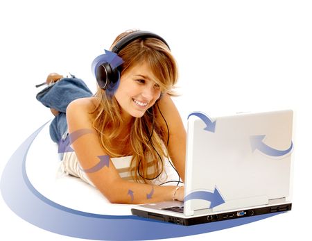 Casual student listening to music on her laptop while studying isolated over a white background