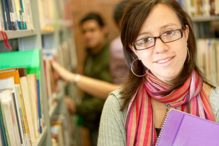 Beautiful female university student at the library