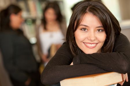 Beautiful female university student at the library