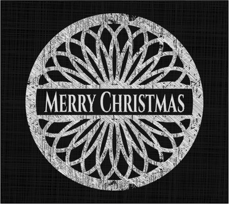 Merry Christmas chalk emblem written on a blackboard