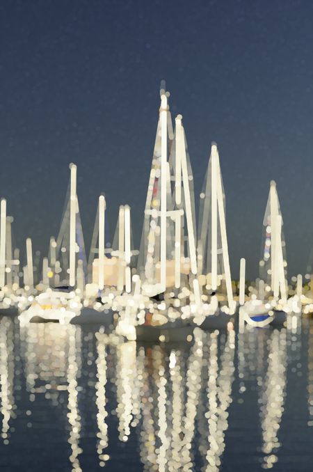 Crepuscular abstract of sailboats, glowing like carnival rides, at anchor together in a tropical marina (one of a series)