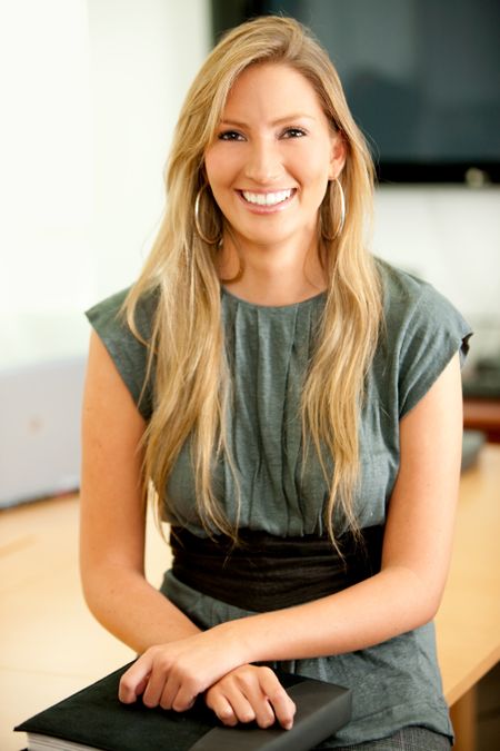 Beautiful business woman in an office smiling