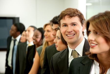 Group of business people in an office smiling