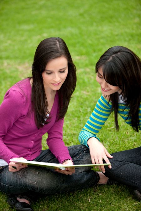 Couple of female students on the floor ourdoors