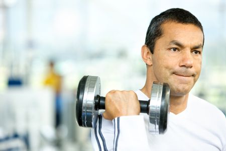 man lifting free weights at the gym