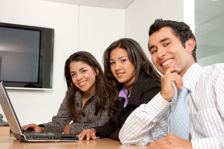 Small business group working with computer smiling