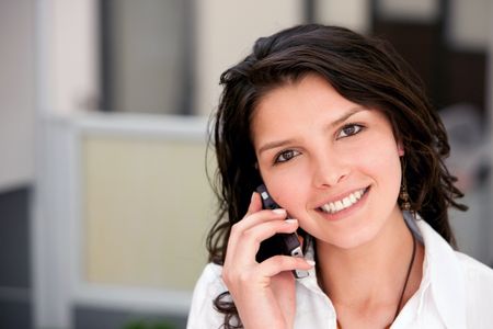 Beautiful business woman on the phone smiling