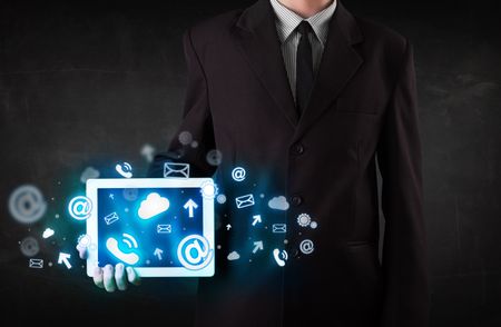 Person holding a white tablet with blue technology icons and symbols