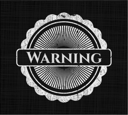 Warning chalkboard emblem written on a blackboard