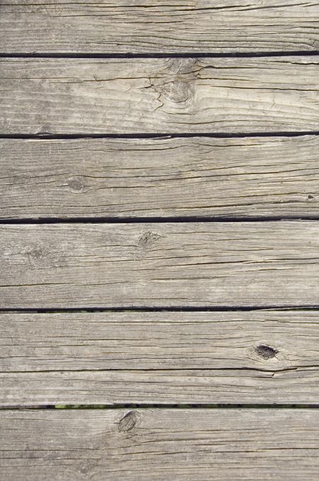 Weathered wooden planks of footbridge, close-up from above