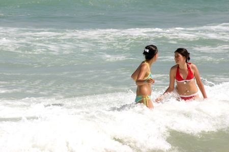 two young girls having fun at the beach