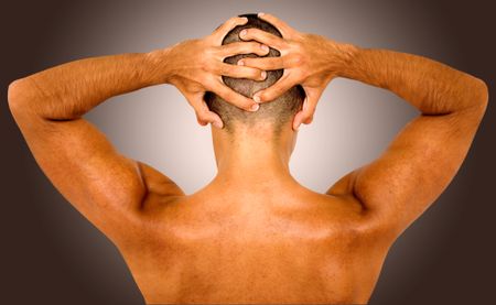 muscular fit man showing his muscles on his back -over a dark background