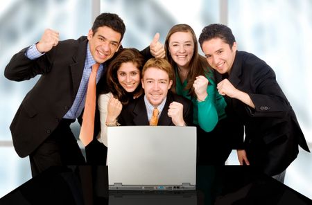 Business success team in an office in front of a laptop computer