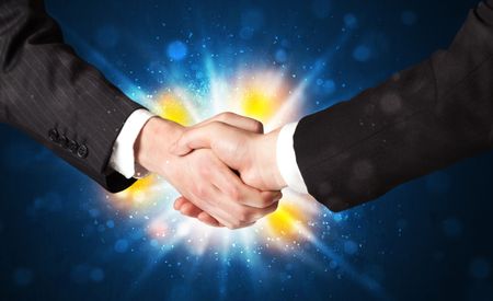 Two business men shaking hands with a successes agreement with explosion