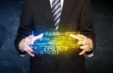 Businessman holding a shining number cloud in front of his body
