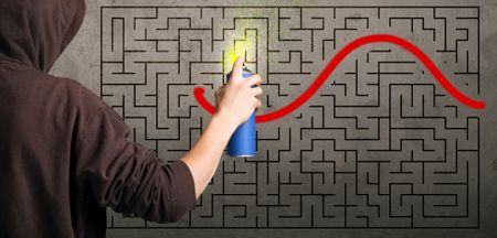 Young urban painter drawing a red solution line on the wall maze