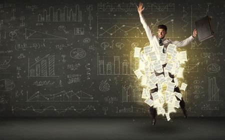 Handsome businessman jumping with paper document cloud around him