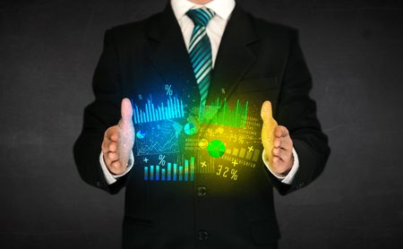 Businessman holding a shining diagram cloud in front of his body
