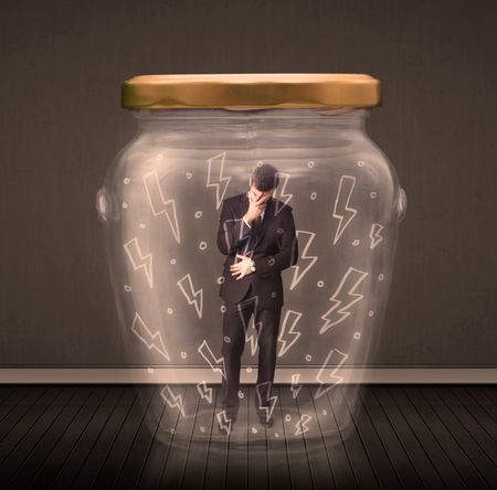 Businessman inside a glass jar with lightning drawings concept on background