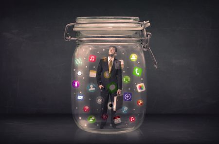 Businessman captured in a glass jar with colourful app icons concept on background