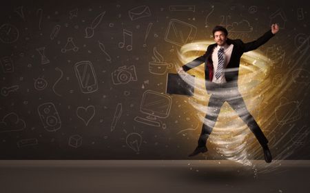 Happy businessman jumping in tornado concept on brown background