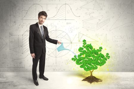 Business man watering a growing green dollar sign tree concept