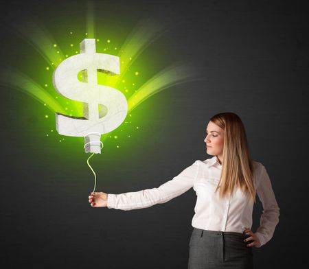 Businesswoman holding a shining, green dollar sign balloon