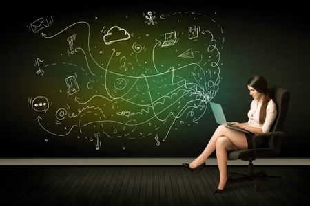Businesswoman sitting in chair holding laptop with media icons concept on background