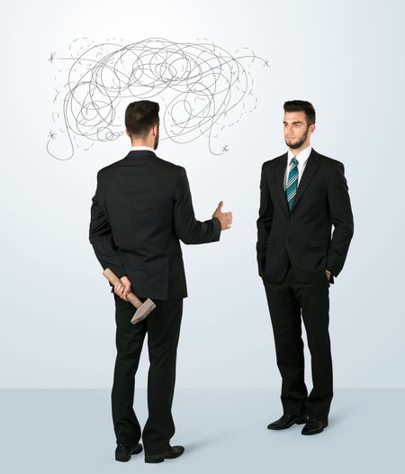 ruthless-businessman-hiding-weapon-weaving-plan-344910842 Ruthless businessman hiding a weapon and weaving plan around his head