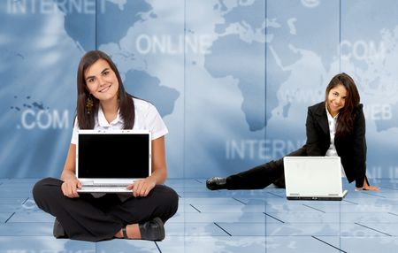 Business women with laptop over a blue internet technology background